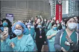  ?? JOHN MINCHILLO-ASSOCIATED PRESS ?? In this April 28file photo Medical personnel attend a daily 7p.m. applause in their honor, during the coronaviru­s pandemic outside NYU Langone Medical Center in the Manhattan borough of New York.