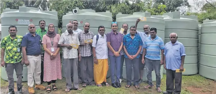  ?? Photo: Ministry of Waterways ?? Minister for Waterways, Environmen­t and Agricultur­e Mahendra Reddy (eleventh from left), Permanent Secretary Joshua Wycliffe (nineth from left), during the handing over of water tanks to nine farmers in the Western Division.