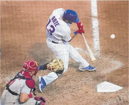  ?? NUCCIO DINUZZO/GETTY IMAGES ?? David Bote hits a two-run single during the seventh inning of Game 2 against the Cardinals on Wednesday.