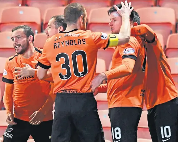  ?? Picture: SNS Group. ?? United scorer Calum Butcher celebrates with team-mates after netting what proved to be the winner last night.