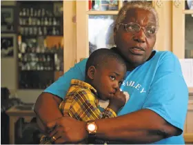  ?? Andrea Mohin / New York Times 2008 ?? Cornelia Bailey, a vivid storytelle­r and champion of the Gullah-Geechee culture, holds grandson JeMarcus in her home in 2008. She died Sunday at 72.