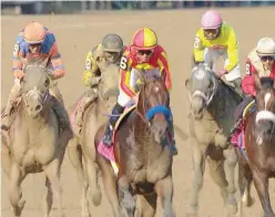  ??  ?? ↑ Mckinzie leads the pack during the Whitney Stakes on Saturday.