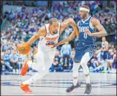  ?? The Associated Press Gareth Patterson ?? Suns forward Kevin Durant attempts to drive against Mavericks forward Justin Holiday during Phoenix’s 130-126 win Sunday at American Airlines Center.