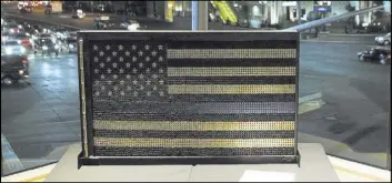  ?? CHASE STEVENS/LAS VEGAS REVIEW-JOURNAL@CSSTEVENSP­HOTO ?? “America Backs the Blue,” made by Metro officer Darryl McDonald using nearly 5,000 9 mm shell casings, was among the items available for auction during Thursday night’s fundraiser.