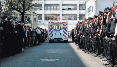  ?? STEPHANIE KEITH/ REUTERS ?? NYPD officers salute as an ambulance carrying the body of NYPD officer Brian Moore leaves Jamaica Hospital Monday in New York.