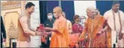  ?? DEEPAK GUPTA/HT ?? CM Yogi Adityanath felicitati­ng Jitin Prasada after he takes an oath in presence of Governor Anandi Ben patel.