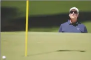  ?? CHARLIE RIEDEL/AP ?? PHIL MICKELSON watches his bunker shot on the seventh hole during third round at the Masters tournament at Augusta National Golf Club on Saturday in Augusta, Ga.