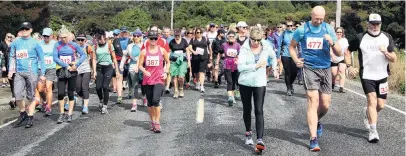  ?? PHOTOS: GLENDA LANDRETH ?? Fresh start . . . The walkers head off on their 15.5km walk in the Papatowai Challenge on Saturday.
