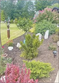  ?? File photo ?? Helping maintain public flower beds is just one of the benefits of being a Benton County Master Gardener.