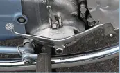  ??  ?? Very continenta­l heel’n’toe gear lever, note the 102-3-4 gear position indicator. Despite the location of its oil tank, the pipe unions confirm that this is a dry-sump design