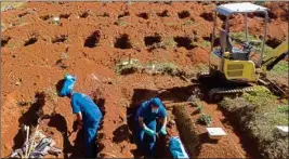  ?? PTI ?? Cemetery workers exhume the remains of people buried three years ago at the Vila Formosa cemetery, which does not charge families for the gravesites, in Sao Paulo, Brazil