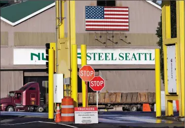  ?? AP Photo/Elaine Thompson, File ?? Steel work: In this Feb. 25, 2016 file photo, a truck carries a load at the Nucor Steel plant in Seattle. U.S. companies pursuing exemptions from President Donald Trump’s tariff on imported steel are accusing American steel manufactur­ers of spreading...