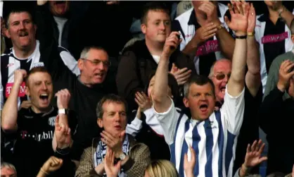  ?? Photograph: Matthew Lewis/Getty Images ?? Adrian Chiles, with Frank Skinner to his right, celebrate West Bromwich Albion scoring against Barnsley at a match in 2007.