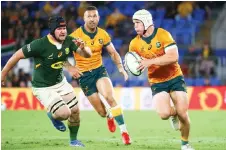  ?? — AFP file photo ?? Hooper (right) runs with the ball during the Rugby Championsh­ip match against South Africa at Cbus Super Stadium in Gold Coast.