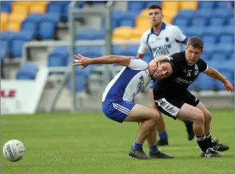  ??  ?? Newtown’s Dean Odlum tries an unorthodox method of getting the better of St Pat’s full-back Shane Murley during the SFC clash in Joule Park Aughrim.