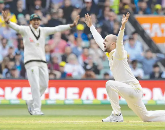  ??  ?? Australian spinner Nathan Lyon (right) appeals successful­ly for an LBW decision against England's Alastair Cook.