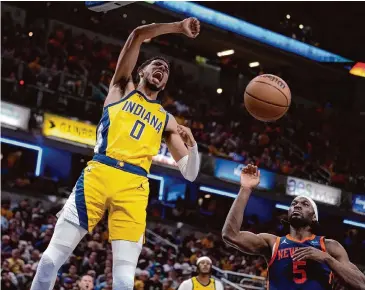  ?? Michael Conroy/Associated Press ?? Pacers guard Tyrese Haliburton goes in for a dunk during the second half of Sunday’s Game 4 win over the Knicks. The lopsided victory was the third-biggest postseason win in Indiana’s franchise history.