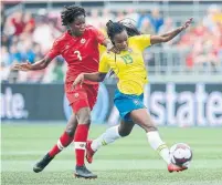  ?? ADRIAN WYLD THE CANADIAN PRESS ?? Brazil's Ludmila protects the ball from Canada's Kadeisha Buchanan in Ottawa on Sunday during a friendly match.