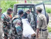  ?? AFP ?? Army personnel and policemen move the body of martyred soldier on Monday in the Bhimber Gali sector of Rajouri