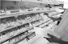  ?? — Reuters photo ?? A pharmacist selects pharmaceut­ical drugs at a pharmacy. Trump has railed against the industry and vowed to bring prices of pharmaceut­ical drugs down but experts say Trump will struggle to realise that goal due to a system that involves a complex web...