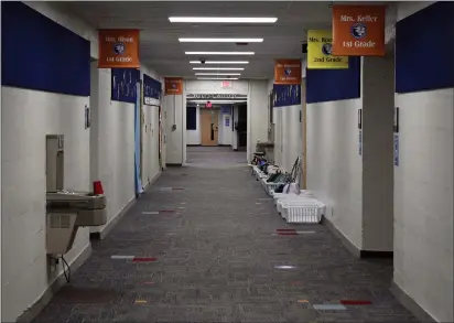  ?? PHOTOS BY MARK CAVITT — MEDIANEWS GROUP ?? Above, below: A Commerce Elementary School’s halls and classrooms sit empty on June 30. Michigan’s public school enrollment saw historic declines in 2020, the highest since the Great Recession.