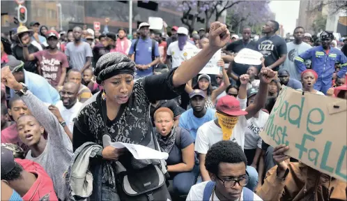  ?? PICTURES: OUPA MOKOENA ?? LIST OF DEMANDS: Bacebile Nkosi, a parent, joined students from various universiti­es in a #FeesMustFa­ll protest at the Union Buildings in Pretoria yesterday.