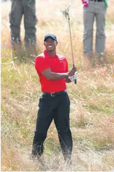  ?? AP PHOTO ?? Tiger Woods plays out of the rough on the 12th hole Sunday at Royal Liverpool in Hoylake, England. Woods shot a 75 in the final round and finished with a 6-over 294.