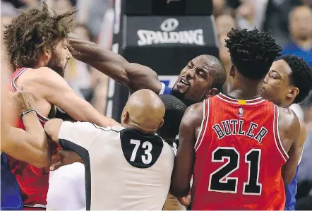  ?? — THE CANADIAN PRESS ?? Raptors forward Serge Ibaka and Chicago Bulls centre Robin Lopez exchange blows during a scuffle in the second half of their game in Toronto on Tuesday night.