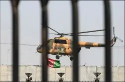  ?? WAKIL KOHSAR/AFP VIA GETTY IMAGES ?? An Afghan Air Force helicopter rovers near the Afghan Parliament house in Kabul on Monday.