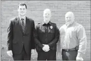  ?? Submitted Photo ?? Sgt. Chris Kelley and Police Chief Chuck Skaggs pose with Officer Bradley McNelly (center), who recently returned to work at the Gravette Police Department. McNelly graduated from the Arkansas Law Enforcemen­t Training Academy on April 20 after 13 weeks...