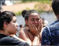  ?? AP/ANDRE PENNER ?? A student cries Wednesday outside the Raul Brasil school in Suzano, Brazil, after a shooting that authoritie­s said left 9 people dead, including the two gunmen.