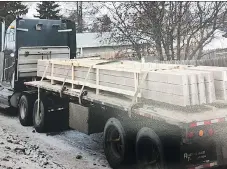  ??  ?? Court exhibit photos show a Carmont Constructi­on truck loaded with the type of sound wall that fell on 19-year-old Austyn Schenstead in 2016.