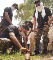  ?? — PTI ?? Bomb disposal squad members try to defuse a live rocket that was spotted by some fishermen in a branch of Sirhind Canal in Bathinda district on Saturday.