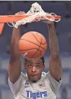  ?? JOE RONDONE/THE COMMERCIAL APPEAL ?? Memphis Tigers forward D.J. Jeffries dunks the ball against the South Florida Bulls during their game at the Fedexforum on Tuesday, Dec. 29, 2020.