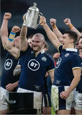  ?? ?? Cameron Redpath, right, lifts the Calcutta Cup after making his debut