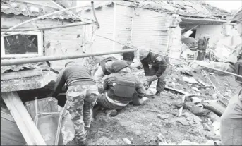  ?? ?? Police officers help rescue people from the rubble after an air strike, during Russia's invasion of Ukraine, in Bakhmut, Donetsk Region, Ukraine, in this handout picture released May 19, 2022 State Emergency Service of Ukraine/Handout via REUTERS