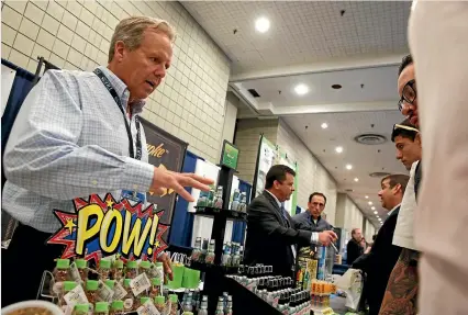  ?? REUTERS ?? A representa­tive of a cannabis-based product company talks to attendees during the Cannabis World Congress & Business Exposition in New York.