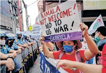  ?? | Reuters ?? A PROTESTER holds a placard during a protest against US Vice-president Kamala Harris’ visit to the Philippine­s, in Manila, yesterday.