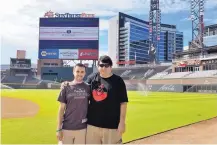  ?? FRANK GENNARIO/VIA AP ?? Frank Gennario and his son, Tony, pose at SunTrust Park in Atlanta earlier this baseball season.