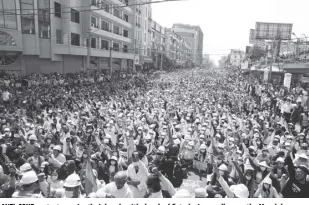  ?? AP Photo ?? Anti-coup protesters raise their hands with clenched fists during a rally near the Mandalay Railway Station in Mandalay, Myanmar on February 22. in the month since February 1 coup, the mass protests occurring each day are a sharp reminder of the long and bloody struggle for democracy in a country where the military ruled directly for more than five decades.