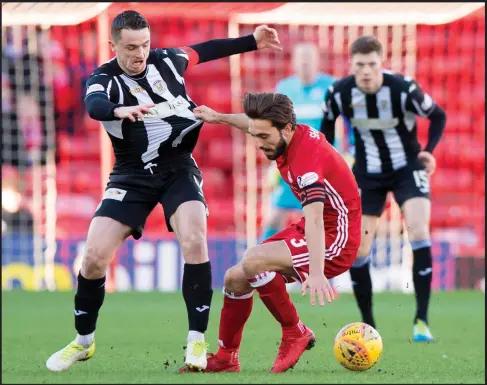  ??  ?? St Mirren captain Stephen McGinn comes in for some rough treatment from Aberdeen counterpar­t Graeme Shinnie in the 4-1 defeat at Pittodrie