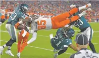  ?? DAVID RICHARD/ASSOCIATED PRESS ?? Browns tight end David Njoku is upended Thursday against the Eagles in Cleveland.