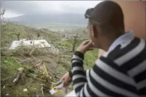  ?? CARLOS GIUSTI — THE ASSOCIATED PRESS ?? A local looks at the devastatio­n left by Hurricane Maria, in Yabucoa, Puerto Rico, Thursday. As of Thursday evening, Maria was moving off the northern coast of the Dominican Republic with winds of 120 mph (195 kph). The storm was expected to approach...