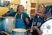  ?? Ronald Cortes / Contributo­r ?? Myara Kirby, from left, and Addison Williams laugh as they and Victoria Taylor prepare food.