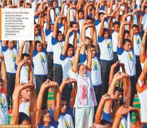  ?? PTI ?? India’s Prime Minister Narendra Modi performs yoga along with thousands of others on 4th Internatio­nal Yoga Day, in Dehradun, Uttarakhan­d, yesterday. DEHRADUN, INDIA