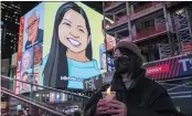  ?? YUKI IWAMURA — THE ASSOCIATED PRESS FILE ?? A person holds a candle during a vigil in New York’s Times Square in honor of Michelle Alyssa Go, a victim of a subway attack several days earlier.