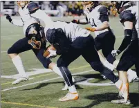  ??  ?? Vacaville High School linebacker Kyler Abramowicz scoops up a loose ball and heads down the sideline with a convoy of teammates en route to a 92-yard touchdown on a fumble recovery at the end of the first half.