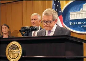  ?? KANTELE FRANKO — THE ASSOCIATED PRESS ?? Ohio Gov. Mike DeWine, right, and Public Safety Director Tom Stickrath announce that the State Medical Board ignored credible evidence in 1996 that an Ohio State University team doctor had been sexually abusing male students for years, during a news conference Friday in Columbus.