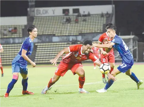  ?? — Photo courtesy of Augustine Jumat. ?? MARKED MAN: Sabah striker Hector Ramos forces his way into the UKM FC penalty box in the Premier League match at the Likas Stadium last night.