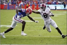  ?? JOHN RAOUX — THE ASSOCIATED PRESS ?? Alabama wide receiver John Metchie III (8) makes a move to get around Florida cornerback Avery Helm (24) during the second half of an NCAA college football game, Saturday, Sept. 18, 2021, in Gainesvill­e, Fla.